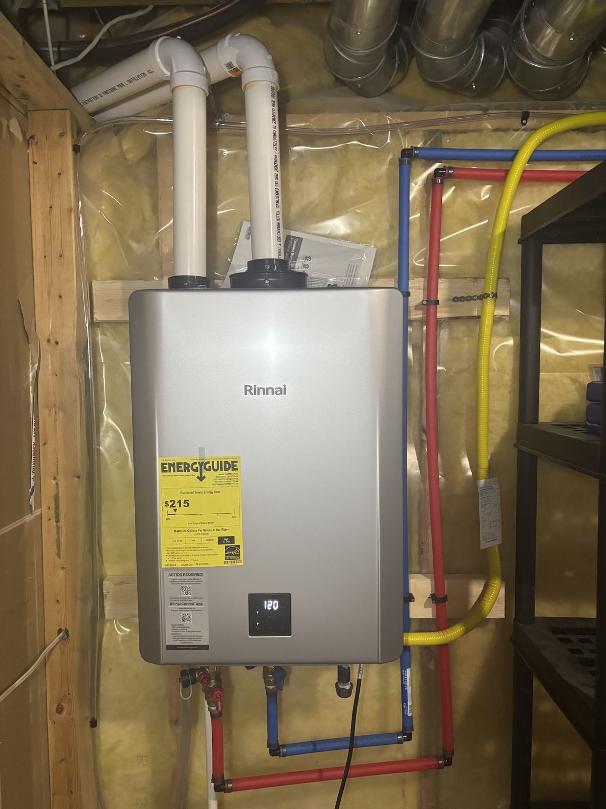 A Rinnai tankless water heater installed on a basement wall